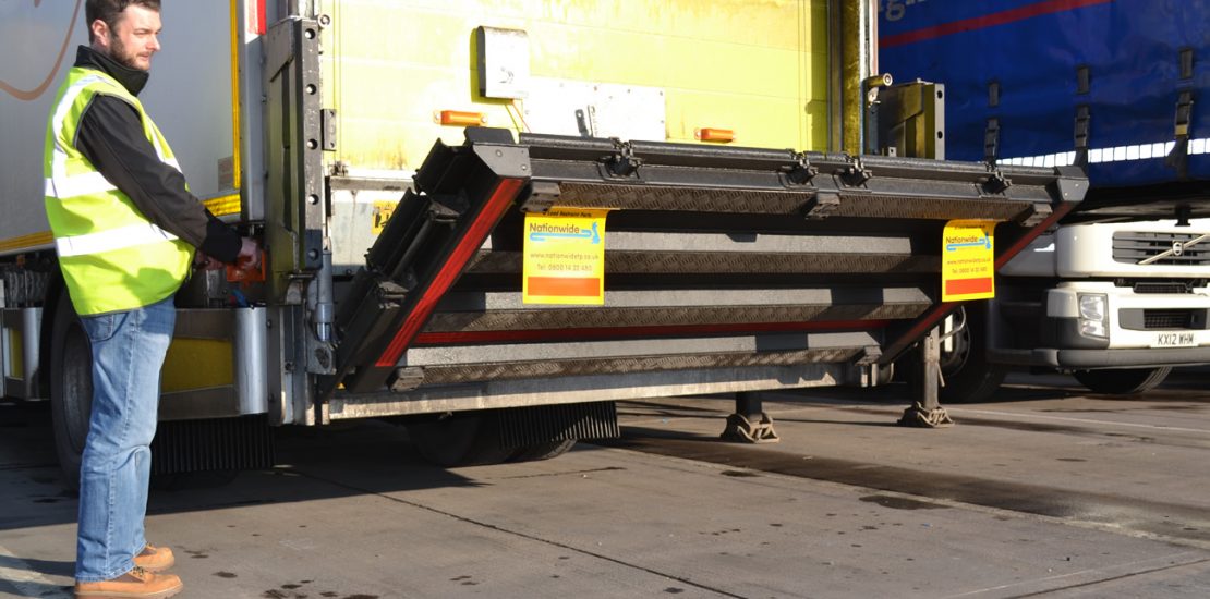 Man operating tail lift.